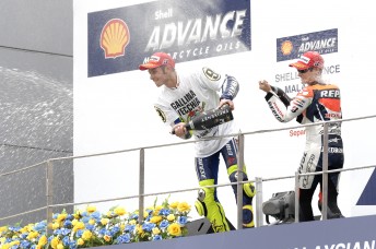Rossi celebrates on the podium after sealing his ninth motorcycle title