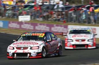 car Fabian Coulthard leads jason Bright at Queenland Raceway