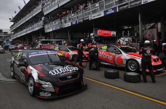 Jonathon Webb passes the TeamVodafone Commodores at Sydney. Next year, Webb will be driving a Triple Eight-built Holden