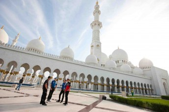The four visiting V8 drivers stand outside the mosque