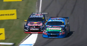 Whincup puts two wheels off track as the Ford blocks the line