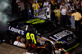 Jimmie Johnson makes his way to collect his record breaking fourth-straight NASCAR Sprint Cup Series title