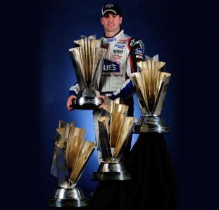 Jimmie Johnson poses with his 2006, 2007, 2008 and 2009 Sprint Cup trophies - in his eight seasons at Sprint Cup level he has never finished outside the top five in points