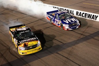 Phoenix race winner Kevin Harvick does a burnout beside team-mate Ron Hornaday Jr, who wrapped up the 2009 Camping World Truck Series title tonight