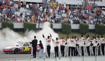 Crew members cheer on Greg Biffle from pit wall after winning at Pocono