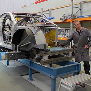 The damaged #22 chassis being straightened at HRT