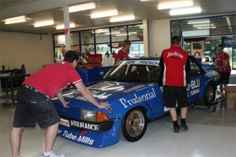 Dick Johnson Racing employees push the Tru Blu Falcon into the musuem