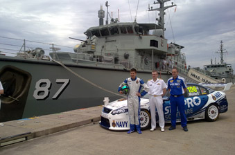 Rising star driver Chaz Mostert, Head Navy Engineering RADM Michael Uzzell and Ford Performance Racing Principal Tim Edwards in front of the V8 Supercar with HMAS Yarra in the background