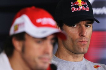 Mark Webber looks at championship leader Fernando Alonso at yesterday