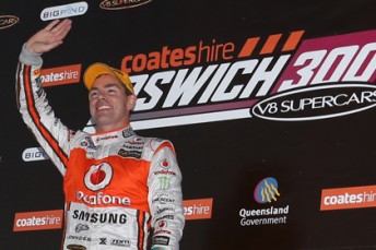 Craig Lowndes celebrates on the podium at Queensland Raceway