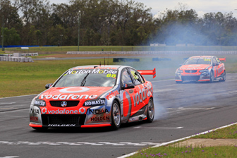 Sebastien Bourdais smokes the tyres in a practice start at Queensland Raceway today