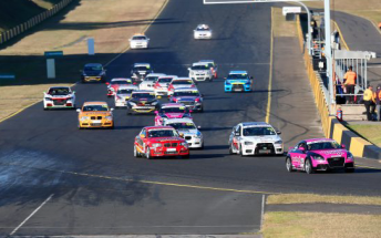 The Australian Production Car Series field heads into Turn 1