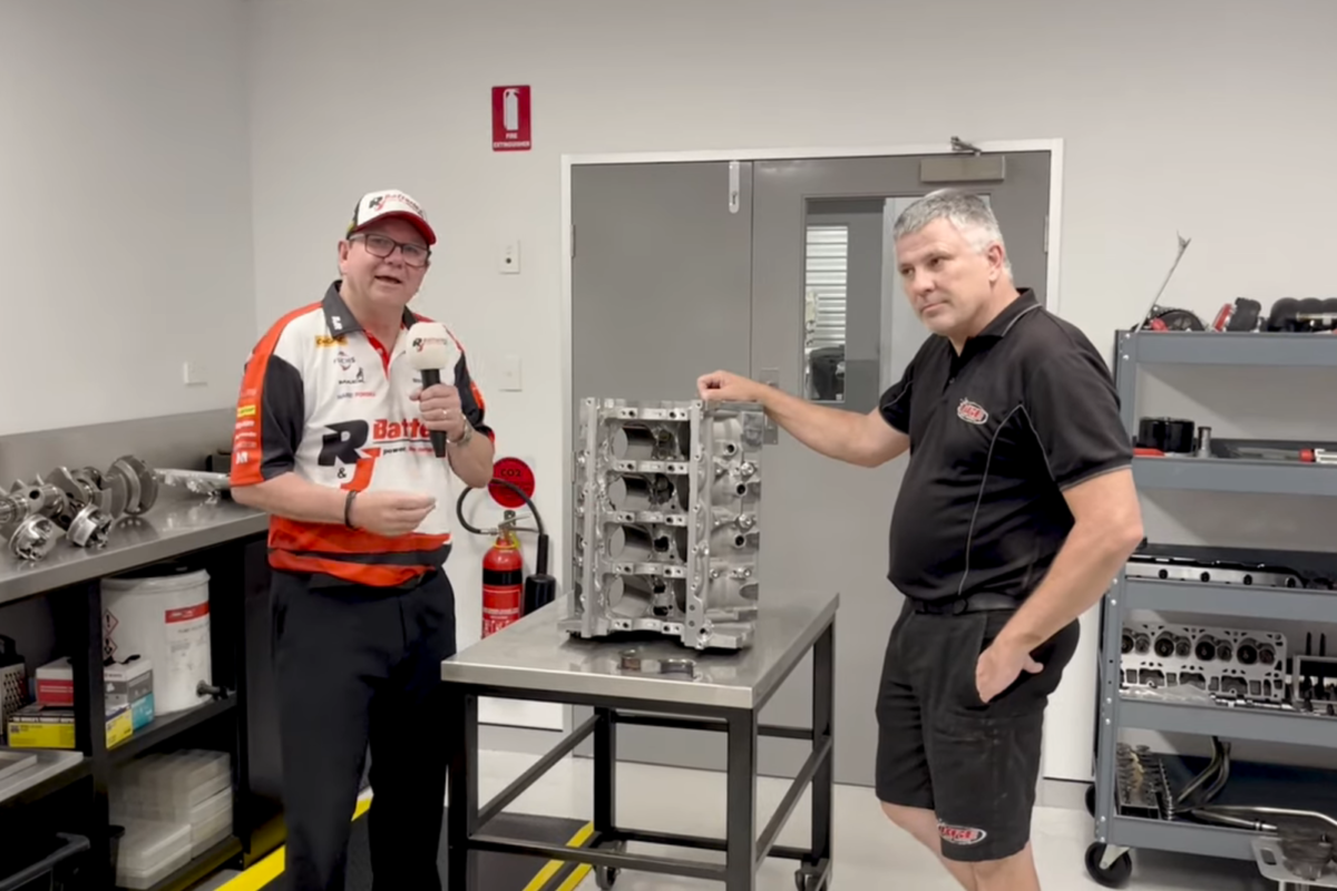 Brad Jones (left) and Kenny McNamara (right) with the remains of the BJR engine which blew up at the Bathurst 1000. Image: Supplied