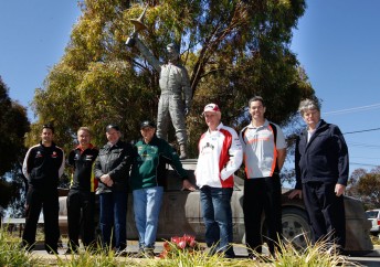 Jamie Whincp, Russell Ingall, Allan Moffat, Jim Richards, Dick Johnson, Craig Lowndes and Colin Bond with the Peter Brock statue at the foot of Mount Panorama