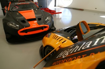 Inside the museum. an Aston Martin sits beside the McLaren MP4-12C