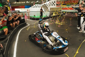 Cam Wilson celebrates after setting a new indoor karting world record for the greatest difference travelled in a 24 hour period