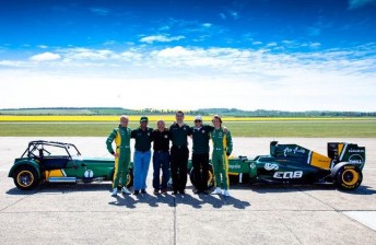 Team Lotus drivers and chiefs pose with a Caterham Seven and the team