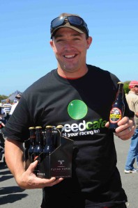 Premier Speedway General Manager David Mills with two prized possessions - a six pack of Grand Ale and a Speedcafe t-shirt! (pic: Ash Budd)