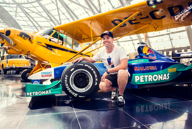 Craig Lowndes among the cars and planes in Hangar-7