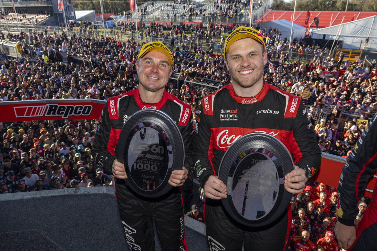 David Russell and Brodie Kostecki holding their trophies on the podium after finishing second in the 2023 Bathurst 1000