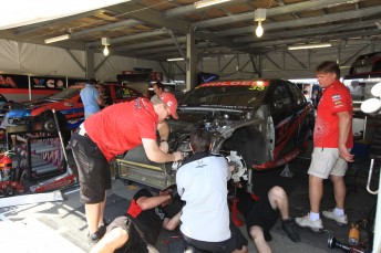 The GRM crew work on the #33 Commodore of Lee Holdsworth. Sticker man Neville Bolton (far right) has a big task!