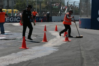 Track officials work on the turn one chicane between V8 Supercar races yesterday