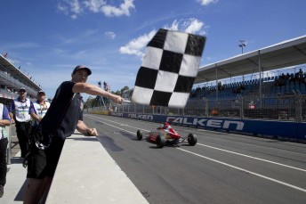 Craig Lowndes unfurls the chequered flag in the closing Australian Formula Ford Championship race in a fitting piece of nostalgia