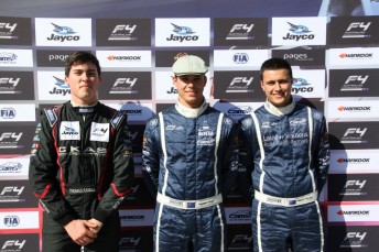 Jordan Lloyd (centre) celebrates victory in the opening Formula 4 race  
