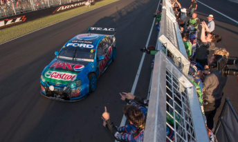 Mostert drives past the FPR crew after taking the chequered flag