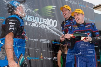Will Davison and Mark Winterbottom celebrate on the podium with engineer Grant McPherson 