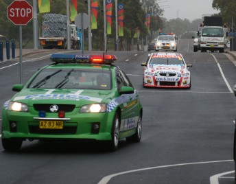 Jason Richards is led around the Homebush street course by a police escort