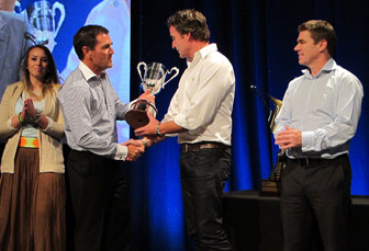 Porsche motorsport manager Jamey Blaikie presents the trophy to Craig Baird