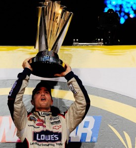 Jimmie Johnson lifts his fourth-straight NASCAR Sprint Cup Series trophy in Homestead, Florida