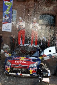Loeb and Elena celebrate winning Rallye de France