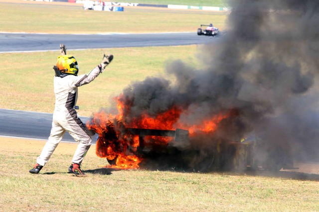 Mark Laucke emerges from his flaming wreck at Queensland Raceway Pic: Matthew Paul Photography