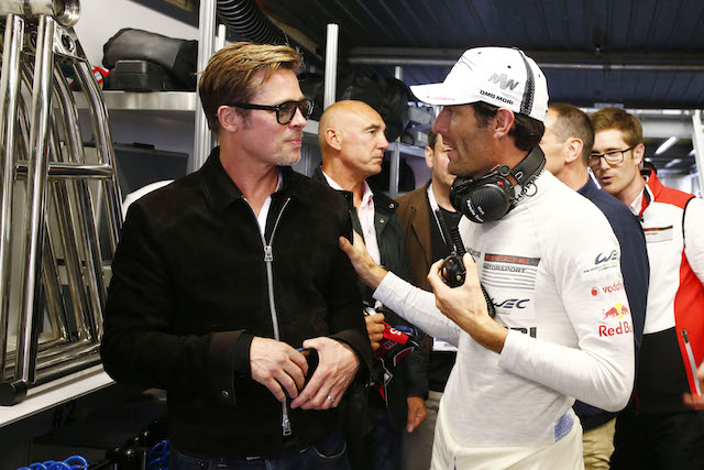 Mark Webber talks to Hollywood actor Brad Pitt during the dramatic Le Mans 24 Hour