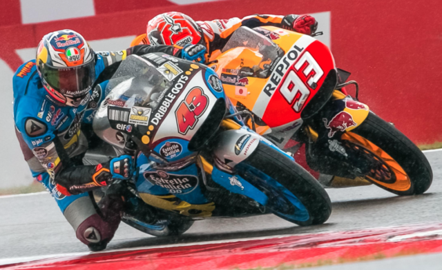 Jack Miller battles with the factory Honda of Marc Marquez on his way to victory at Assen