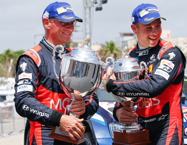 Paddon and Kennard clutching their second-place trophies at Rally Sardinia in June 