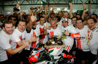 Max Biaggi and the Aprilla team celebrate their world title