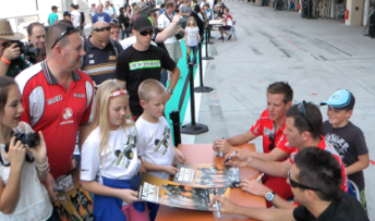James Courtney, Garth Tander and Fabian Coulthard sign autographs for fans in today