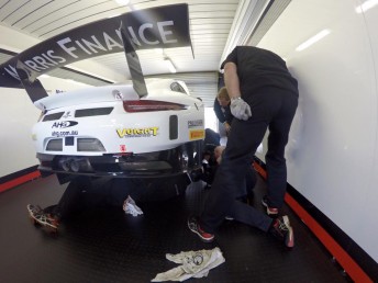 The Walkinshaw Racing crew assess the damage to the rear of the Porsche 