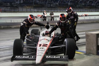 The Penske Racing crew push Will Power behind the wall