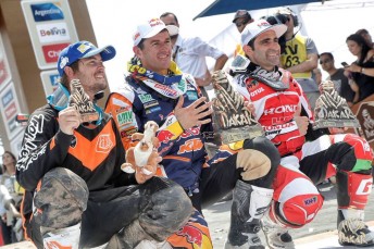 Toby Price celebrates with five time winner Marc Coma and Paulo Goncalves
