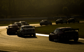 The V8 Supercars pack racing into the dusk at Queensland Raceway last month