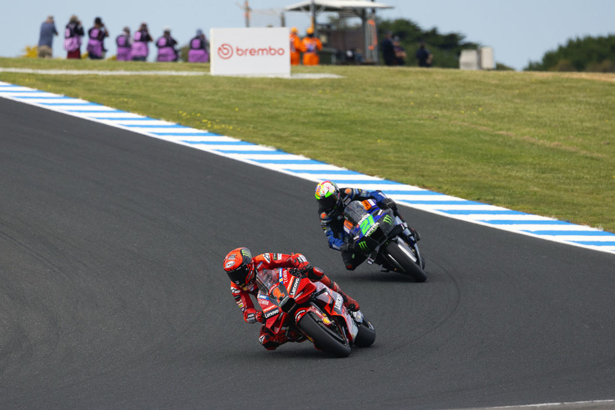 Two MotoGP bikes descend into MG corner at Phillip Island at the 2023 Australian Motorcycle Grand Prix