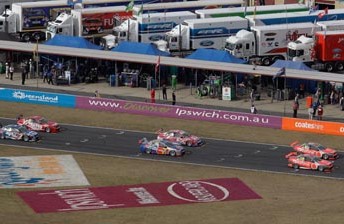 The V8 field prepare to launch at Queensland Raceway on Sunday