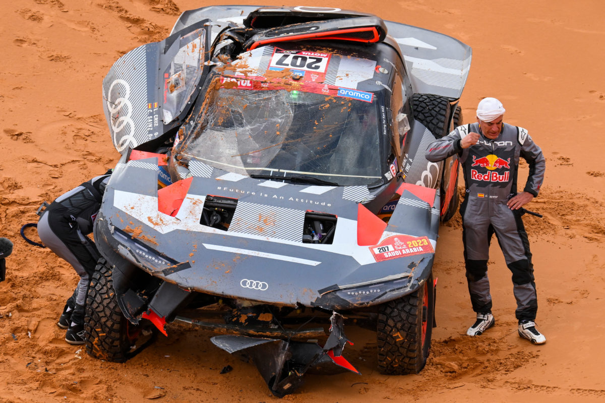 Carlos Sainz (right) and co-driver Lucas Cruz assess their Audi after a crash on Stage 9 of Dakar 2023