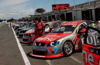 The V8 Supercars field await qualifying in pit lane at Winton