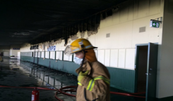 A firefighter assesses the damage in the aftermath to the blaze