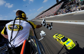 Paul Menard crosses the bricks to win his first NASCAR Sprint Cup victory